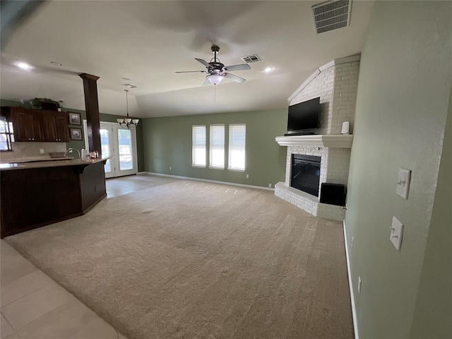10201 Pinckney Ct, Oklahoma City, OK 73162 - unfurnished living room with a fireplace, ceiling fan, light carpet, and vaulted ceiling