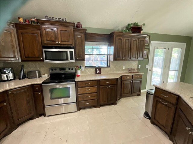 10201 Pinckney Ct, Oklahoma City, OK 73162 - kitchen featuring stainless steel appliances, light countertops, backsplash, and dark brown cabinets