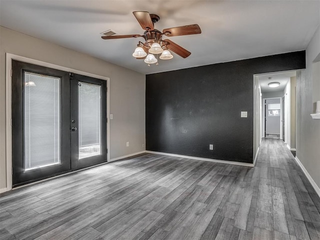 528 Sweetbough St, Jones, OK 73049 - empty room with wood finished floors, french doors, ceiling fan, and healthy amount of natural light