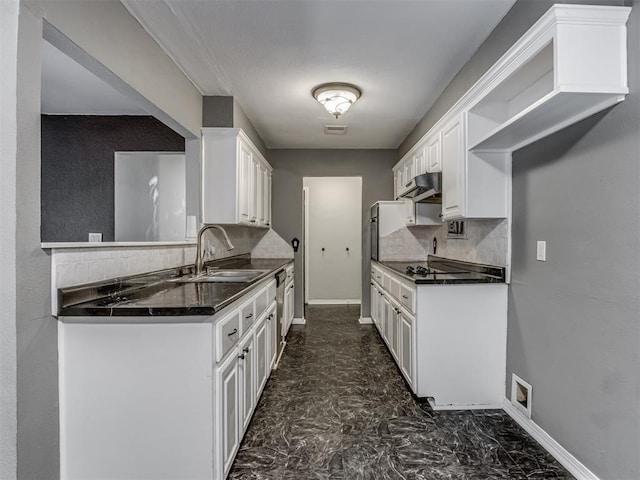 528 Sweetbough St, Jones, OK 73049 - kitchen with dark countertops, backsplash, under cabinet range hood, and white cabinetry