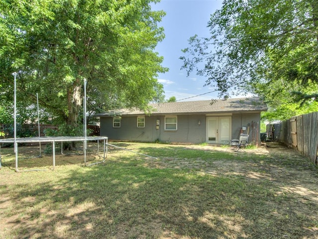 528 Sweetbough St, Jones, OK 73049 - rear view of house with a trampoline, a fenced backyard, and french doors