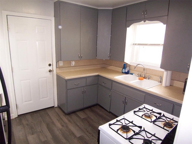 419 W Pulaski St, Shawnee, OK 74804 - kitchen featuring gray cabinetry, gas range gas stove, dark wood-style flooring, and light countertops