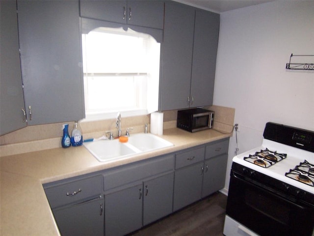 419 W Pulaski St, Shawnee, OK 74804 - kitchen featuring white gas stove, gray cabinetry, and light countertops