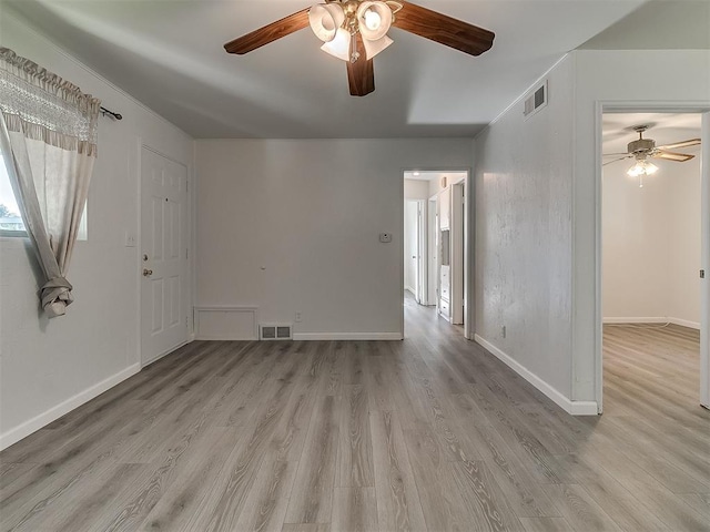 2632 SW 55th St, Oklahoma City, OK 73119 - unfurnished living room with ceiling fan and light wood-style floors