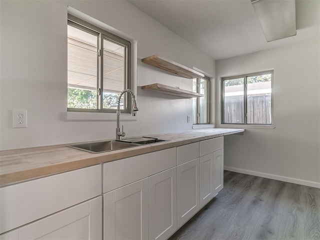 2632 SW 55th St, Oklahoma City, OK 73119 - kitchen with wood counters, plenty of natural light, dark wood-style flooring, and white cabinetry