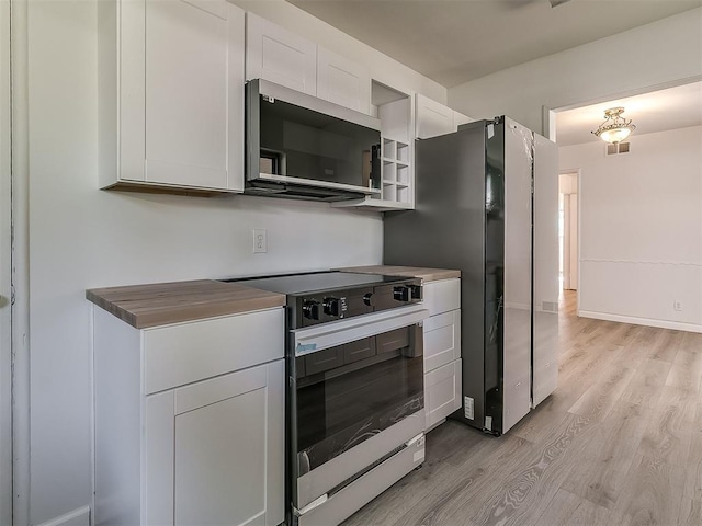 2632 SW 55th St, Oklahoma City, OK 73119 - kitchen with appliances with stainless steel finishes, light wood finished floors, white cabinetry, and open shelves