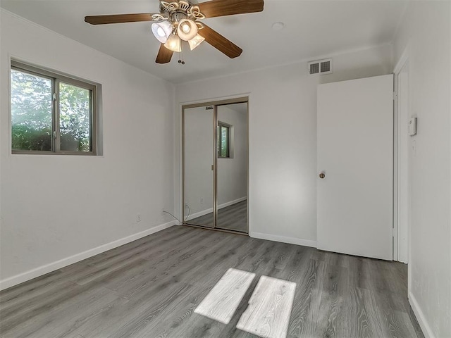2632 SW 55th St, Oklahoma City, OK 73119 - unfurnished bedroom featuring wood finished floors, a closet, and a ceiling fan