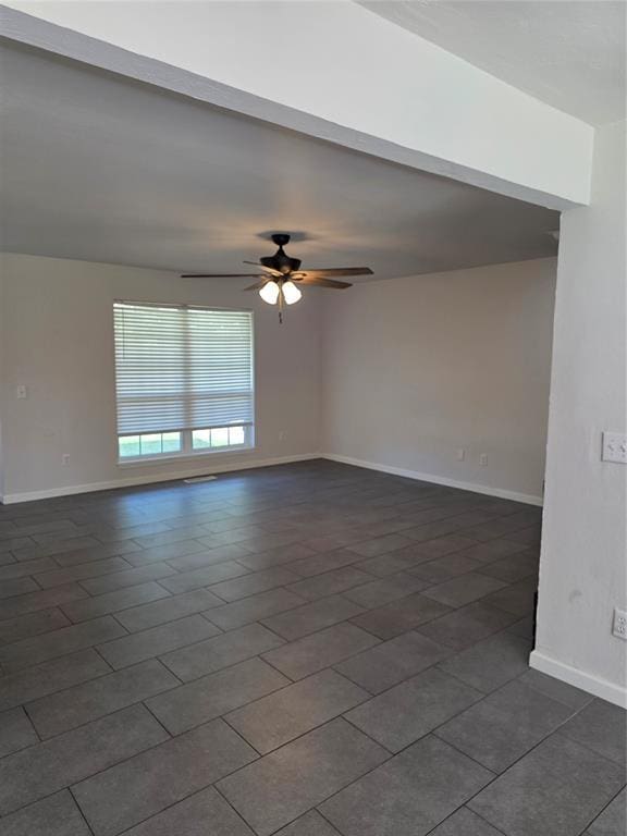 8813 Aaron Dr, Oklahoma City, OK 73132 - spare room with ceiling fan and dark tile patterned flooring