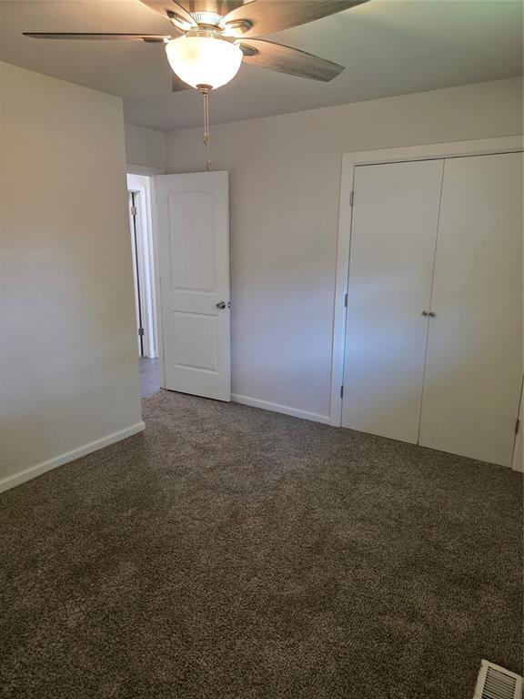 8813 Aaron Dr, Oklahoma City, OK 73132 - unfurnished bedroom featuring carpet, ceiling fan, and a closet