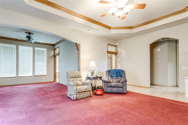 1308 River Birch Dr, Yukon, OK 73099 - sitting room featuring arched walkways, ceiling fan, crown molding, a tray ceiling, and carpet