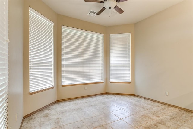 1308 River Birch Dr, Yukon, OK 73099 - empty room with a ceiling fan, plenty of natural light, and light tile patterned floors