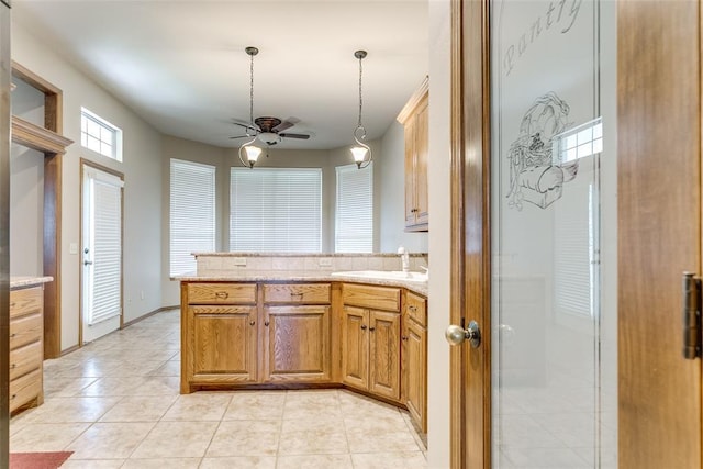 1308 River Birch Dr, Yukon, OK 73099 - kitchen featuring ceiling fan, a peninsula, pendant lighting, and light tile patterned flooring