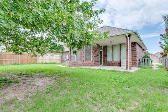 1308 River Birch Dr, Yukon, OK 73099 - back of property featuring brick siding and a patio area