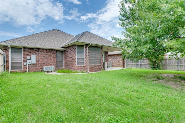 1308 River Birch Dr, Yukon, OK 73099 - rear view of property featuring brick siding and roof with shingles