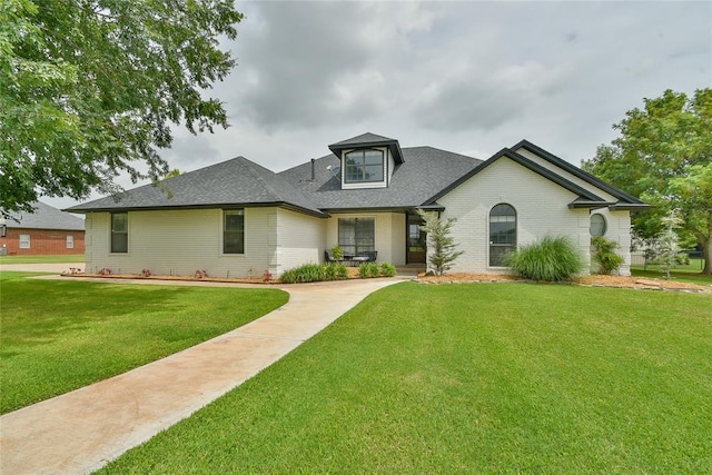 3019 Winding Creek Ln, Piedmont, OK 73078 - view of front of home featuring brick siding, a front yard, roof with shingles, and covered porch