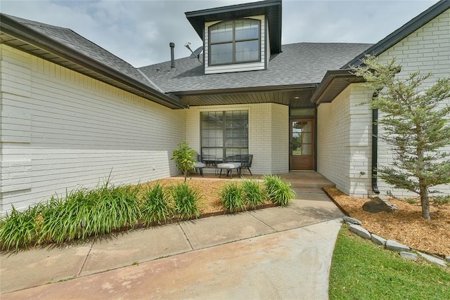 3019 Winding Creek Ln, Piedmont, OK 73078 - doorway to property featuring brick siding and a shingled roof