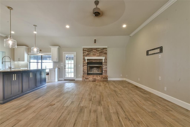 3019 Winding Creek Ln, Piedmont, OK 73078 - unfurnished living room with a ceiling fan, light wood finished floors, crown molding, a fireplace, and recessed lighting