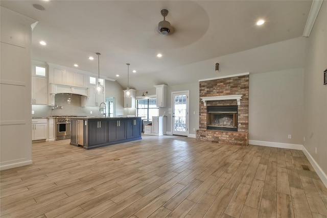3019 Winding Creek Ln, Piedmont, OK 73078 - kitchen featuring open floor plan, ceiling fan, white cabinetry, stainless steel range, and backsplash