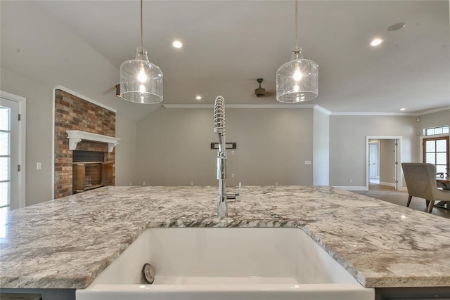 3019 Winding Creek Ln, Piedmont, OK 73078 - kitchen featuring open floor plan, crown molding, recessed lighting, light stone counters, and hanging light fixtures