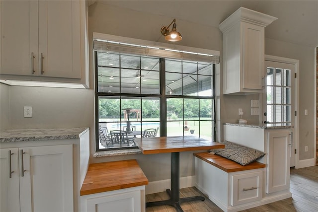 3019 Winding Creek Ln, Piedmont, OK 73078 - kitchen with wood counters, plenty of natural light, light wood-style flooring, and white cabinets