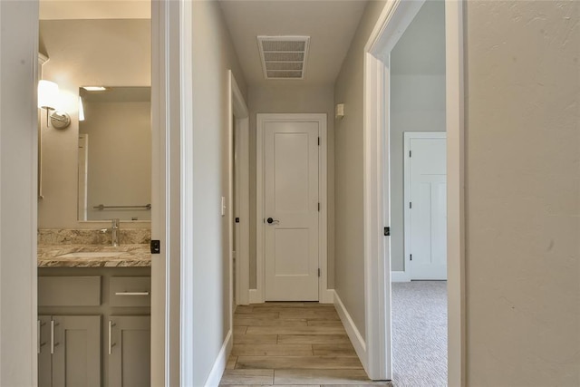 3019 Winding Creek Ln, Piedmont, OK 73078 - hall featuring a sink and light wood-style flooring