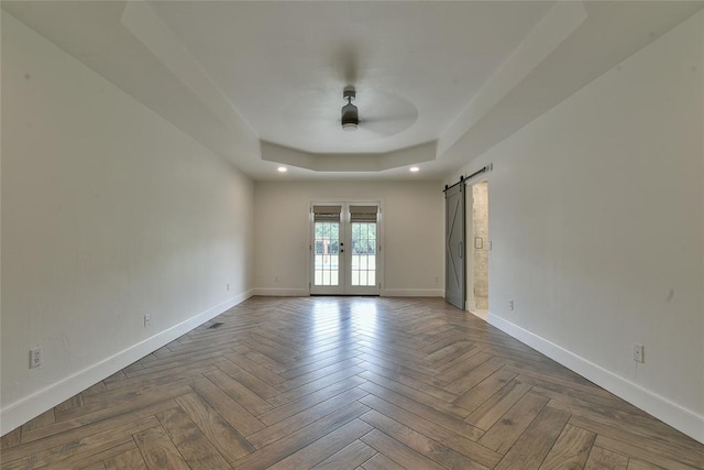 3019 Winding Creek Ln, Piedmont, OK 73078 - spare room featuring a raised ceiling, french doors, a ceiling fan, and a barn door