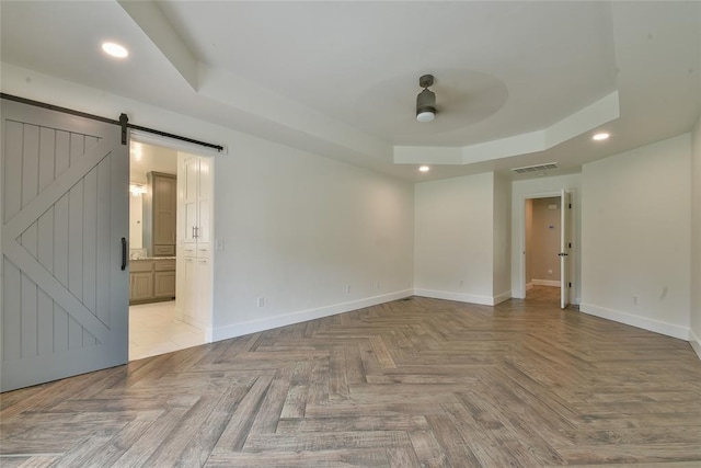 3019 Winding Creek Ln, Piedmont, OK 73078 - empty room featuring a barn door, a tray ceiling, a ceiling fan, and recessed lighting