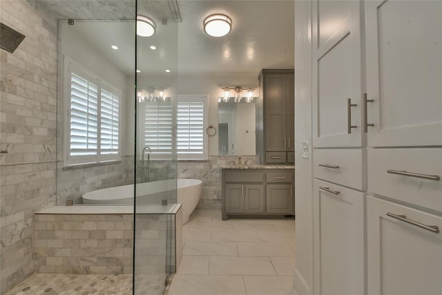 3019 Winding Creek Ln, Piedmont, OK 73078 - bathroom featuring vanity, a freestanding tub, tiled shower, and tile walls