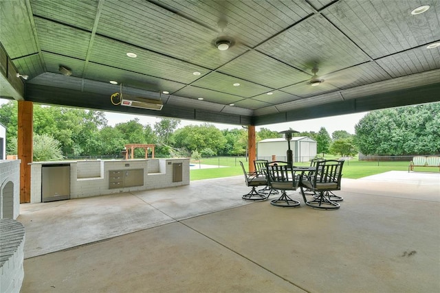 3019 Winding Creek Ln, Piedmont, OK 73078 - view of patio / terrace with area for grilling, a storage unit, outdoor dining area, and a ceiling fan