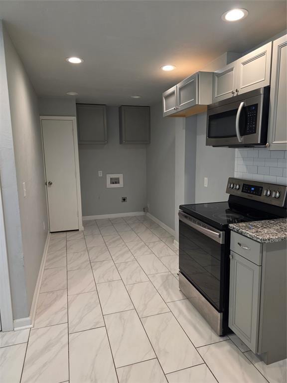 6101 NW 48th St, Warr Acres, OK 73122 - kitchen featuring appliances with stainless steel finishes, gray cabinetry, decorative backsplash, recessed lighting, and stone countertops