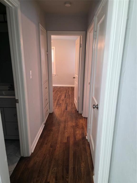 6101 NW 48th St, Warr Acres, OK 73122 - hallway featuring dark wood-style flooring and a sink