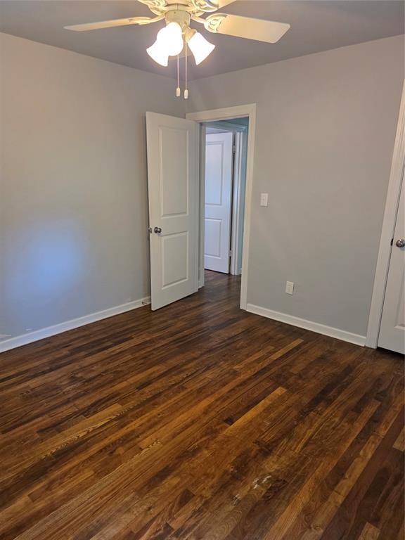 6101 NW 48th St, Warr Acres, OK 73122 - empty room featuring a ceiling fan and dark wood-style floors