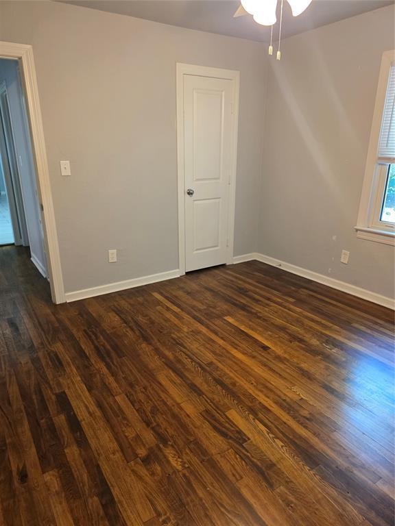 6101 NW 48th St, Warr Acres, OK 73122 - unfurnished room with dark wood-style floors and ceiling fan