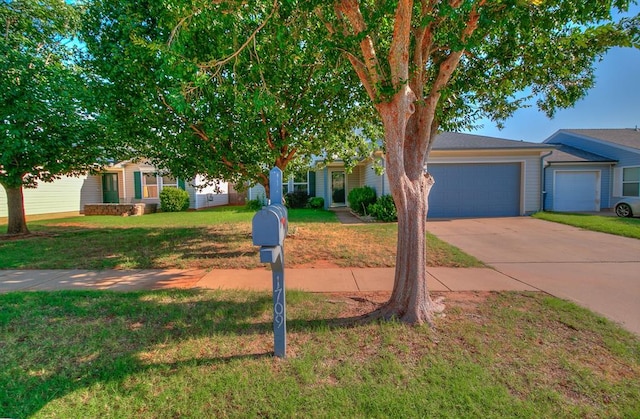 1709 NW 147th St, Edmond, OK 73013 - view of property hidden behind natural elements with concrete driveway, a front yard, and a garage
