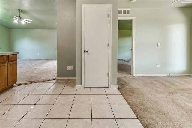 1709 NW 147th St, Edmond, OK 73013 - empty room with light colored carpet, a ceiling fan, and light tile patterned flooring