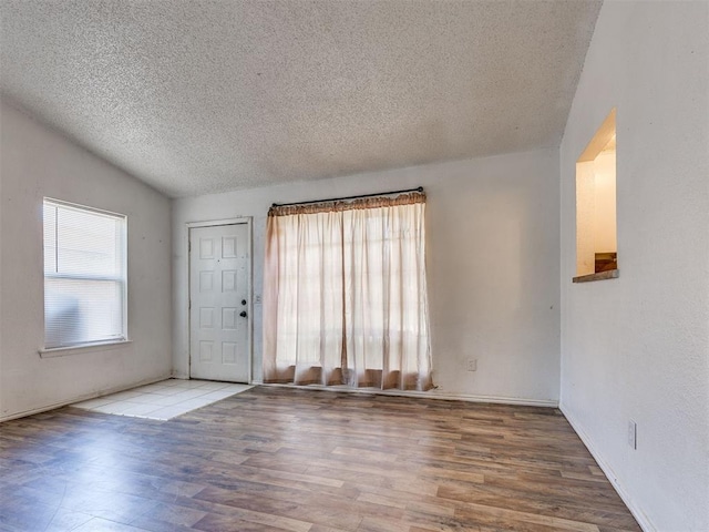 218 Windsor Way, Midwest City, OK 73110 - entryway featuring a textured ceiling, wood finished floors, and lofted ceiling