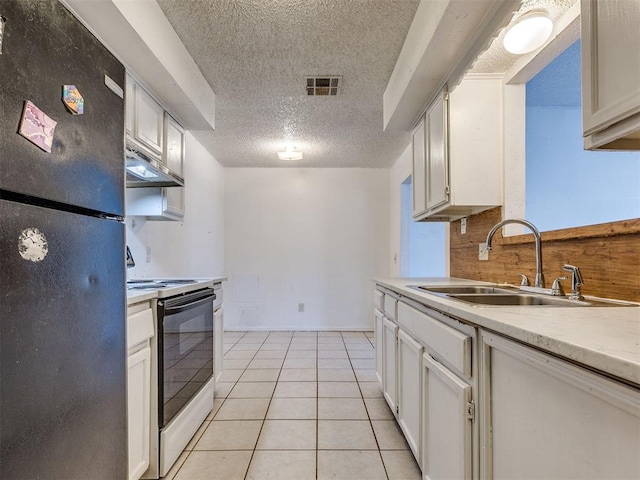 218 Windsor Way, Midwest City, OK 73110 - kitchen with freestanding refrigerator, electric range oven, a textured ceiling, light countertops, and under cabinet range hood