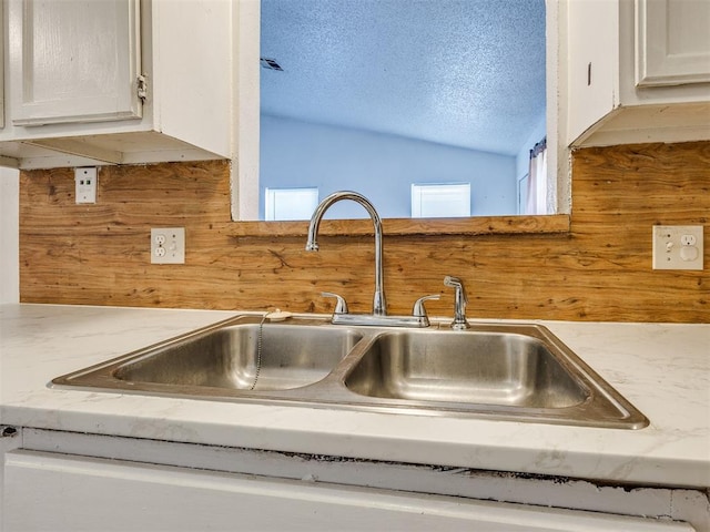 218 Windsor Way, Midwest City, OK 73110 - kitchen view of a textured ceiling and white cabinetry