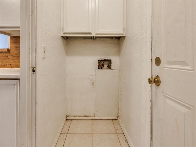218 Windsor Way, Midwest City, OK 73110 - laundry room featuring cabinet space, washer hookup, light tile patterned flooring, and a textured wall