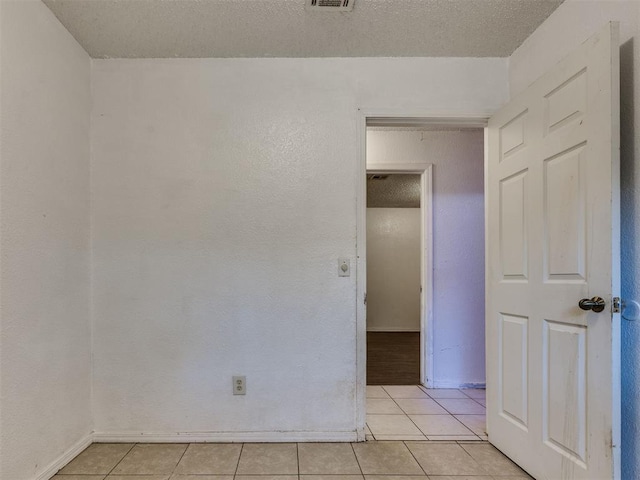 218 Windsor Way, Midwest City, OK 73110 - empty room with light tile patterned flooring and a textured ceiling