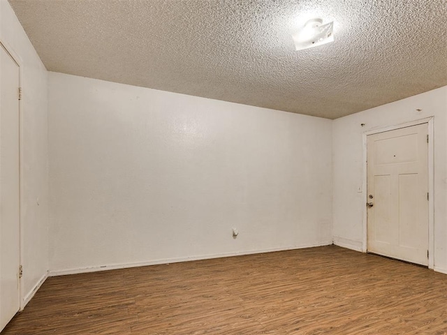 218 Windsor Way, Midwest City, OK 73110 - unfurnished room featuring wood finished floors and a textured ceiling