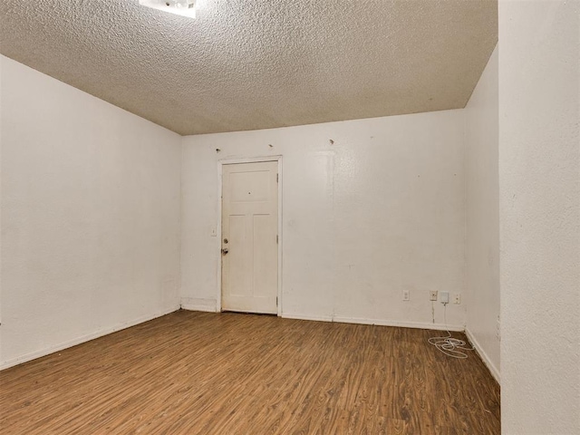 218 Windsor Way, Midwest City, OK 73110 - empty room featuring wood finished floors and a textured ceiling