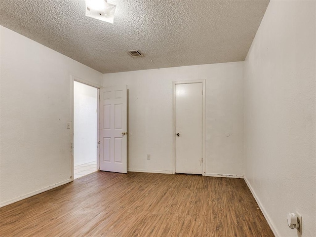 218 Windsor Way, Midwest City, OK 73110 - unfurnished room with wood finished floors and a textured ceiling