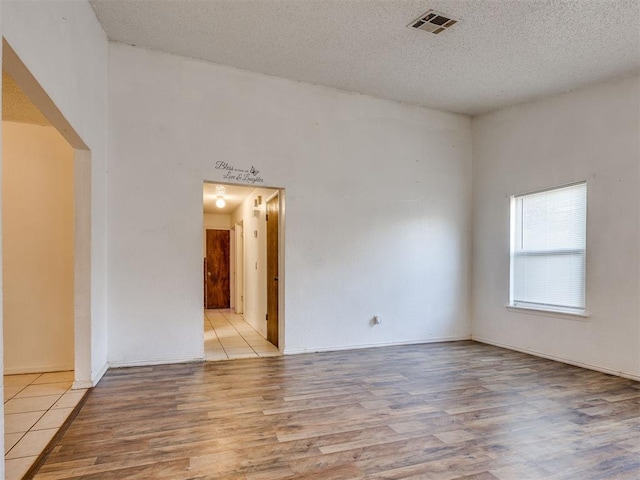 218 Windsor Way, Midwest City, OK 73110 - empty room featuring wood finished floors and a textured ceiling