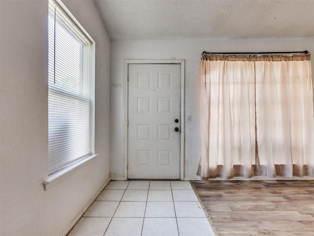 218 Windsor Way, Midwest City, OK 73110 - foyer featuring plenty of natural light, a textured ceiling, and tile patterned flooring