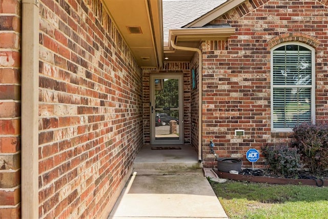 2500 SE 93rd St, Moore, OK 73160 - view of exterior entry featuring brick siding and a shingled roof