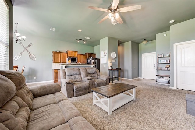 2500 SE 93rd St, Moore, OK 73160 - living room featuring a ceiling fan, a chandelier, and light colored carpet