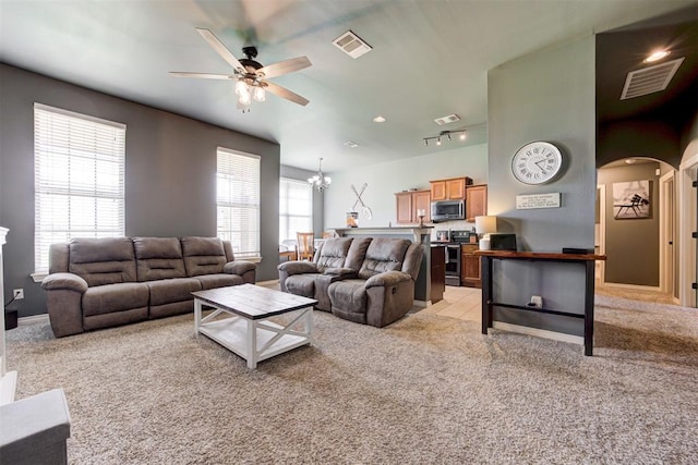 2500 SE 93rd St, Moore, OK 73160 - living room featuring a ceiling fan, light carpet, arched walkways, a chandelier, and track lighting