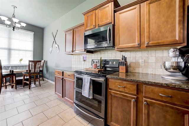 2500 SE 93rd St, Moore, OK 73160 - kitchen with stainless steel appliances, a chandelier, tasteful backsplash, light tile patterned floors, and dark stone counters