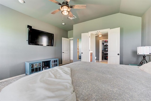2500 SE 93rd St, Moore, OK 73160 - bedroom featuring a walk in closet, vaulted ceiling, and a ceiling fan